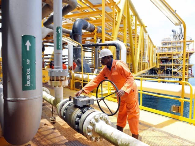 Oil Worker Monitoring a flow line